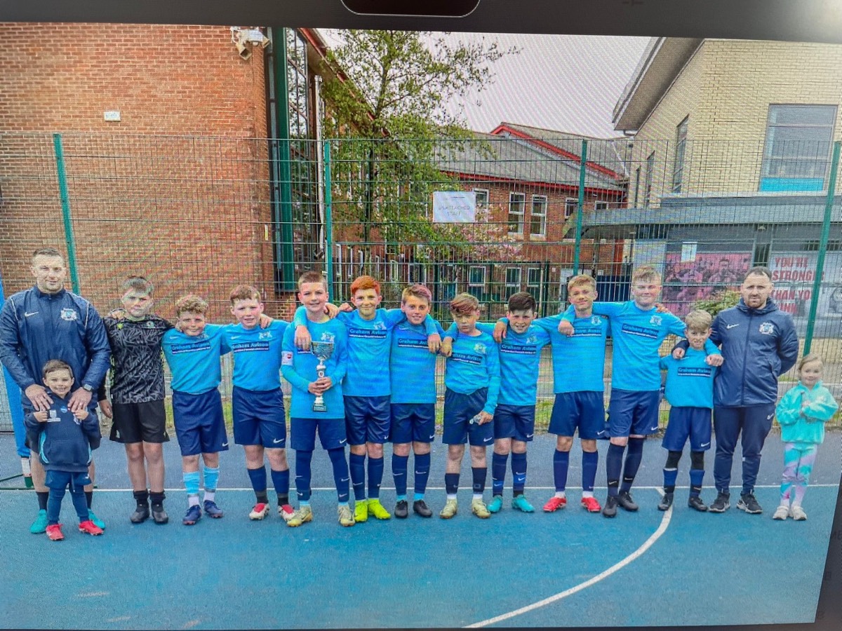 RUFC youth team celebrating with trophy after cup final